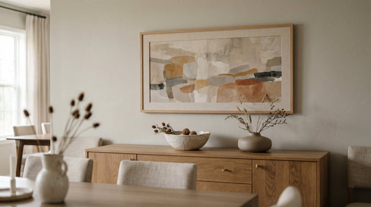 A wide landscape-orientation framed abstract print above a long credenza, an example of horizontal art matched to wide furniture