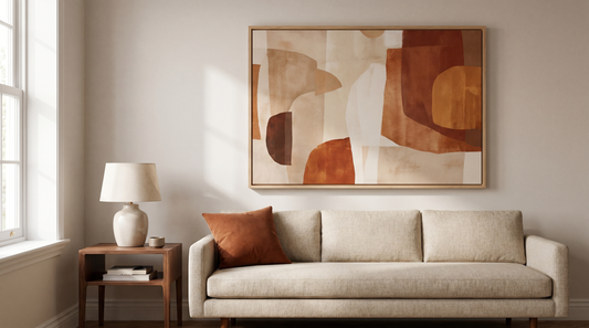 Living room wall art ideas: a large framed print hung above a sofa