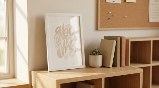Unique teacher appreciation gifts: a framed motivational typography print on a tidy classroom shelf with a small plant