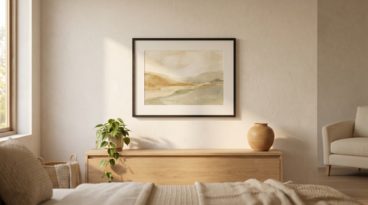 Ready to hang vs DIY framing: a framed print hanging level on a warm white living room wall