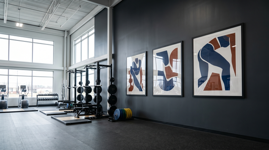 Commercial gym decor ideas: large framed art on a tall weight-floor wall above racks