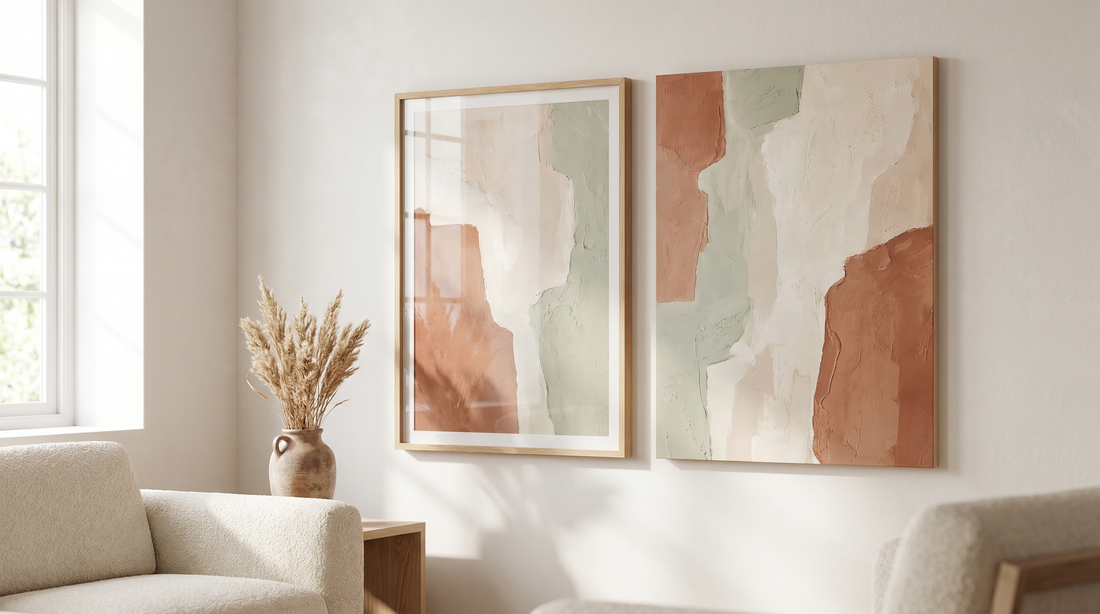 Framed vs unframed abstract wall art shown side by side on a warm neutral living room wall in soft daylight
