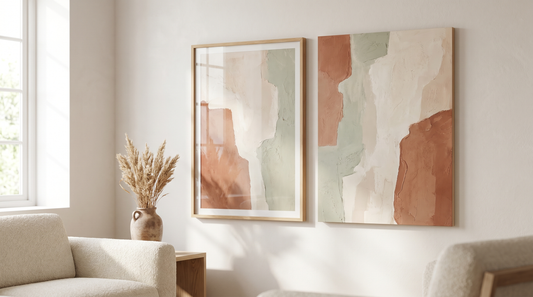 Framed vs unframed abstract wall art shown side by side on a warm neutral living room wall in soft daylight