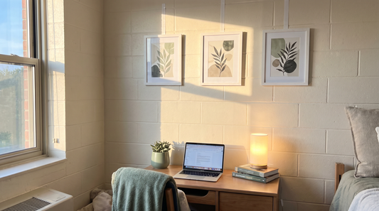 Dorm room wall art ideas: framed prints hung above a desk with command hooks, no holes