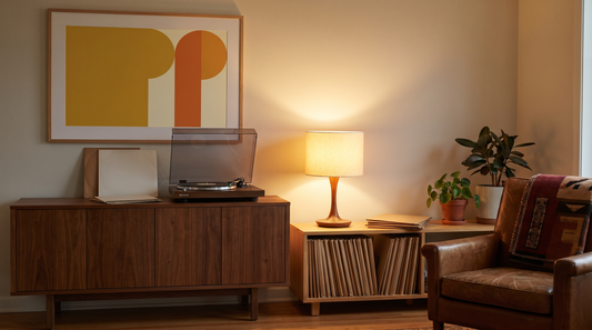 Vinyl record wall decor ideas: framed turntable art print above a record player and a row of records in a warm listening corner