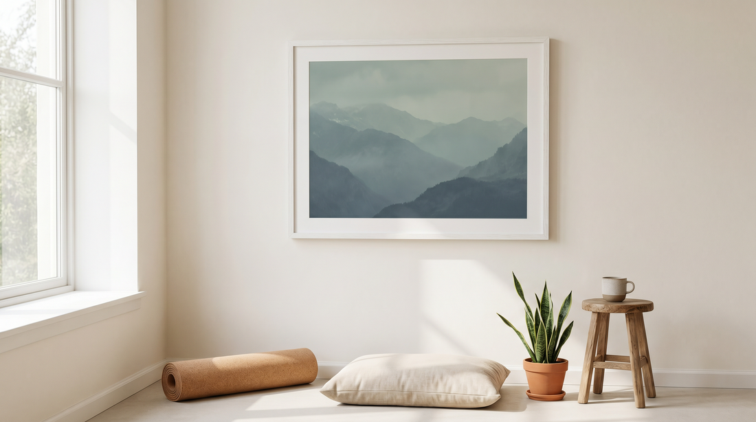 Yoga room decor ideas: a calm corner with a muted mountain print above a folded mat and floor cushion