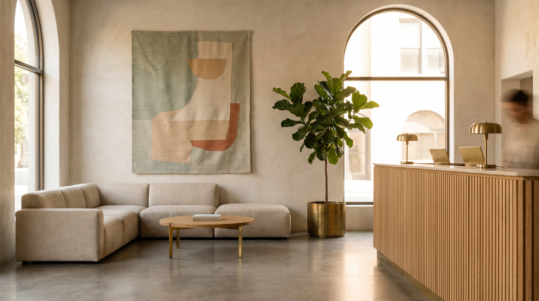 Wall art shaping the business customer experience in a calm hotel lobby with a large framed piece above a seating area