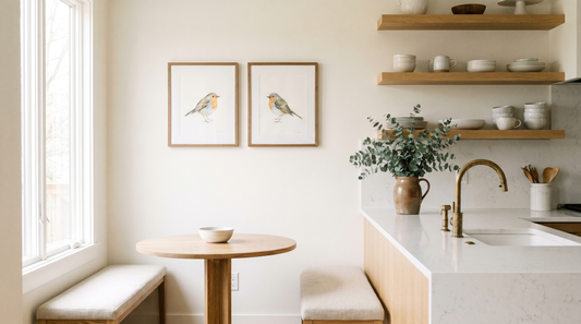 Bird art home decor ideas: framed songbird prints on a warm white kitchen wall
