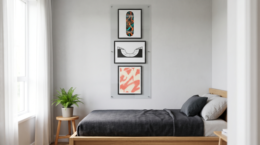 Unique skateboard wall art ideas: a vertical column of three framed deck-shaped graphic prints on a teen bedroom wall