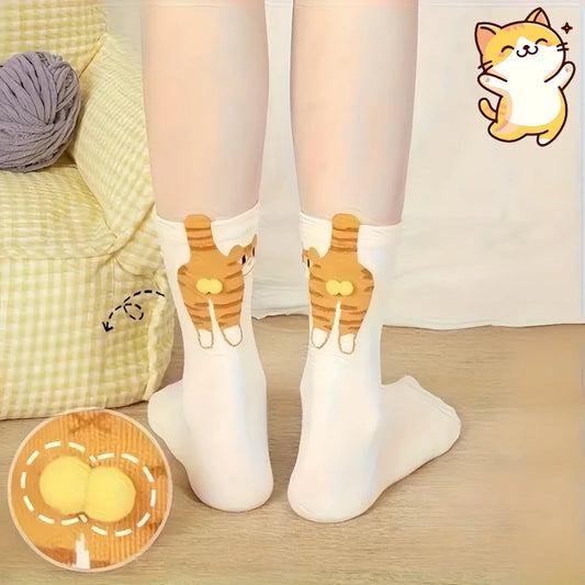 White socks with cat design worn by a person, sitting on a couch with a ball of yarn.