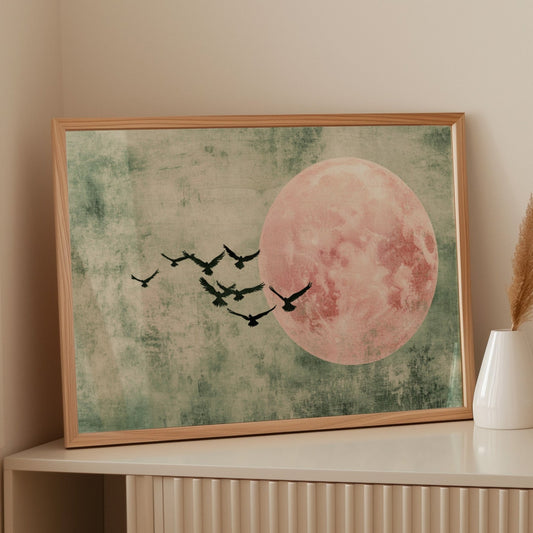 Pink moon wall art with minimalist birds in flight over a textured green sky