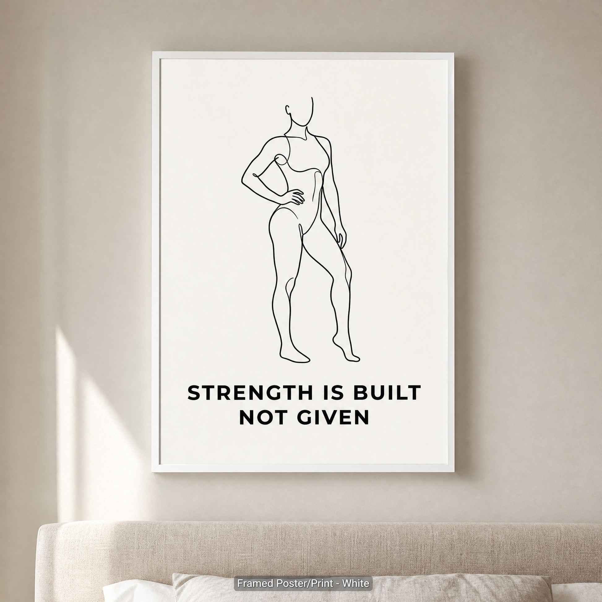 White frame option on a pale wall above a cushioned sofa, minimalist wall art in a calm neutral room