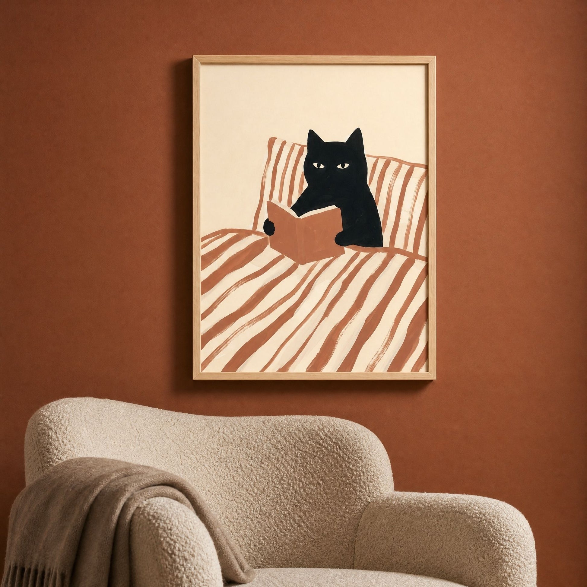 Cat reading poster above a boucle reading chair, cozy reading nook wall art in a pine frame