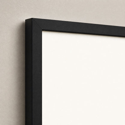 Close-up of the black wood frame corner and the off-white print edge, showing the frame profile and depth