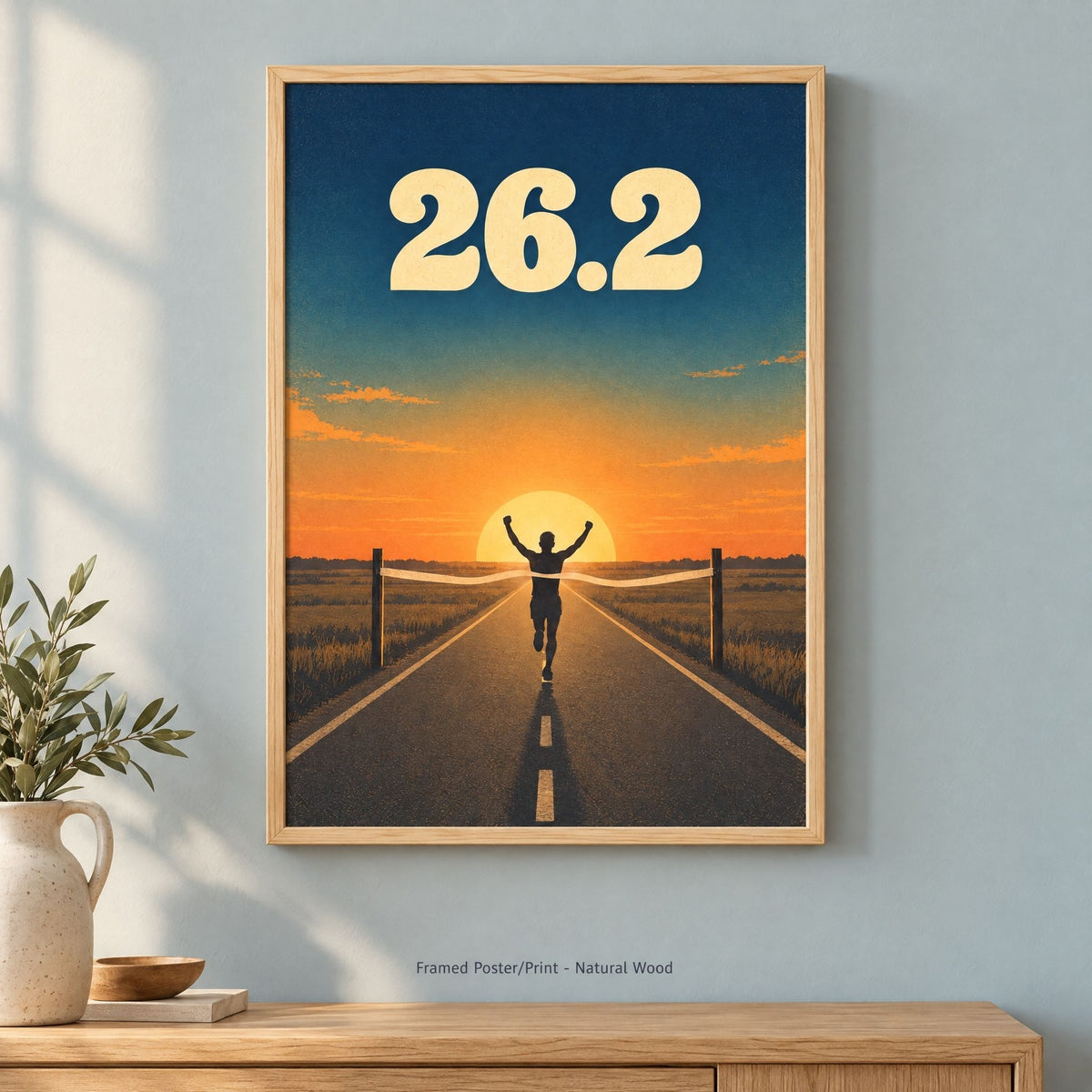 The 26.2 marathon print in the natural wood frame option, light pine with visible grain, hung on a pale wall