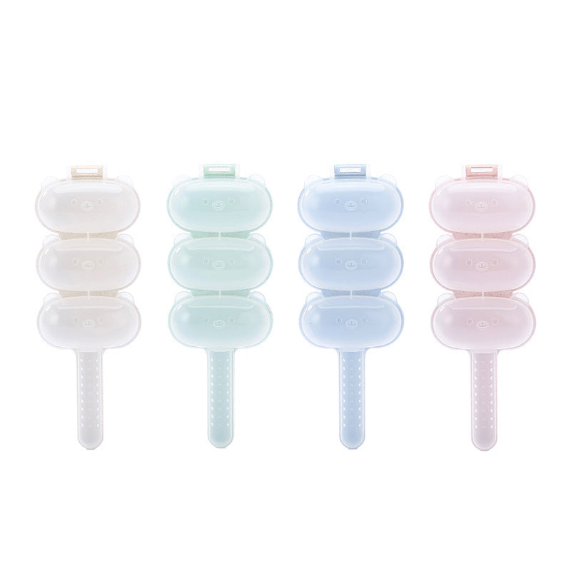 Four pastel-colored rice ball molds on a white background