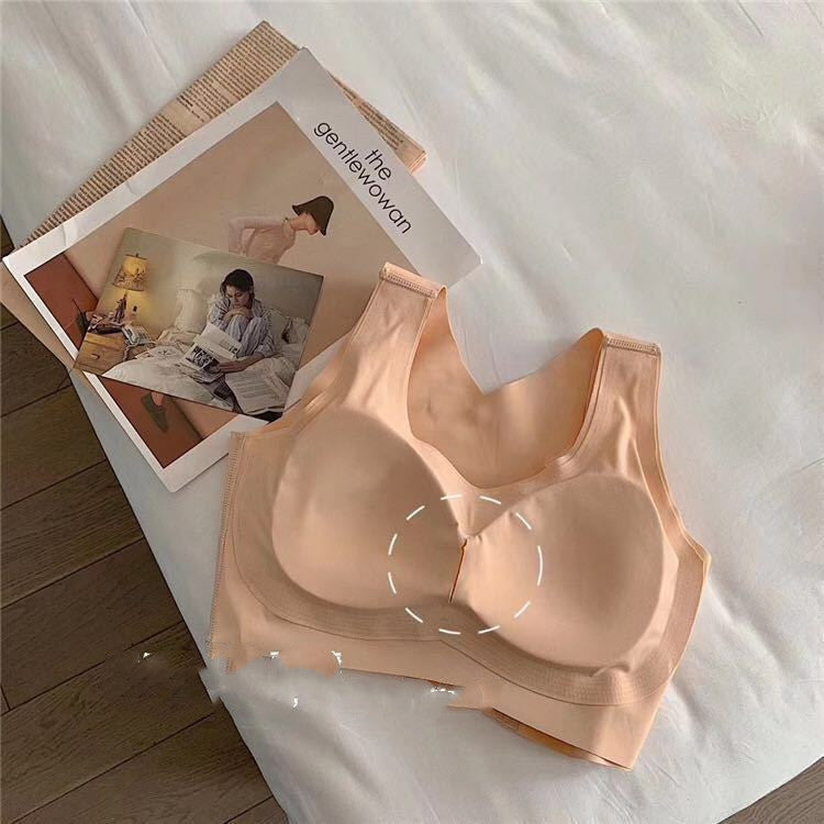 Beige bra on a white surface with a magazine in the background