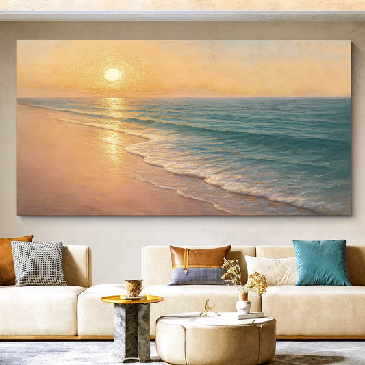 Soft golden sunset over a calm sea and sandy shore, printed on a canvas hanging above a cream sofa