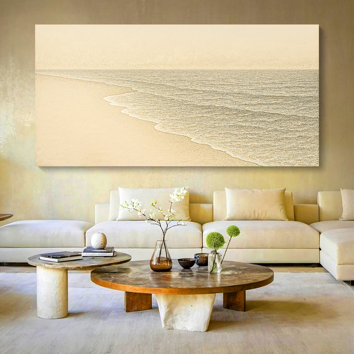 Pale cream beach with soft white surf, canvas above a cream sofa