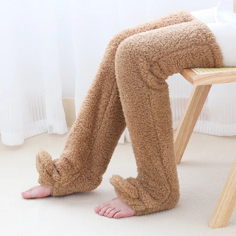 Person sitting wearing beige fuzzy knee socks for home comfort