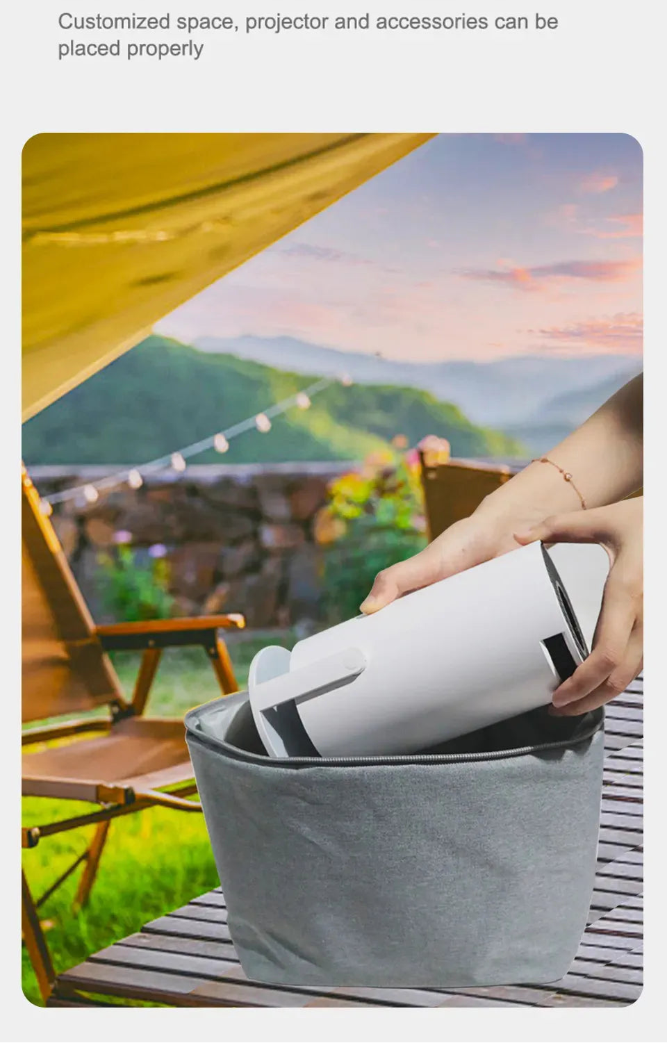 Person holding a white portable projector with a scenic background