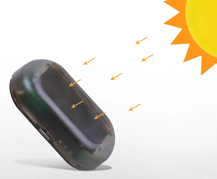 Solar dummy car alarm light blinking on dashboard at night.
