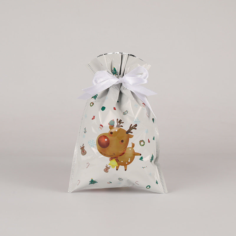 Gift bag with a reindeer design and white ribbon on a light gray background