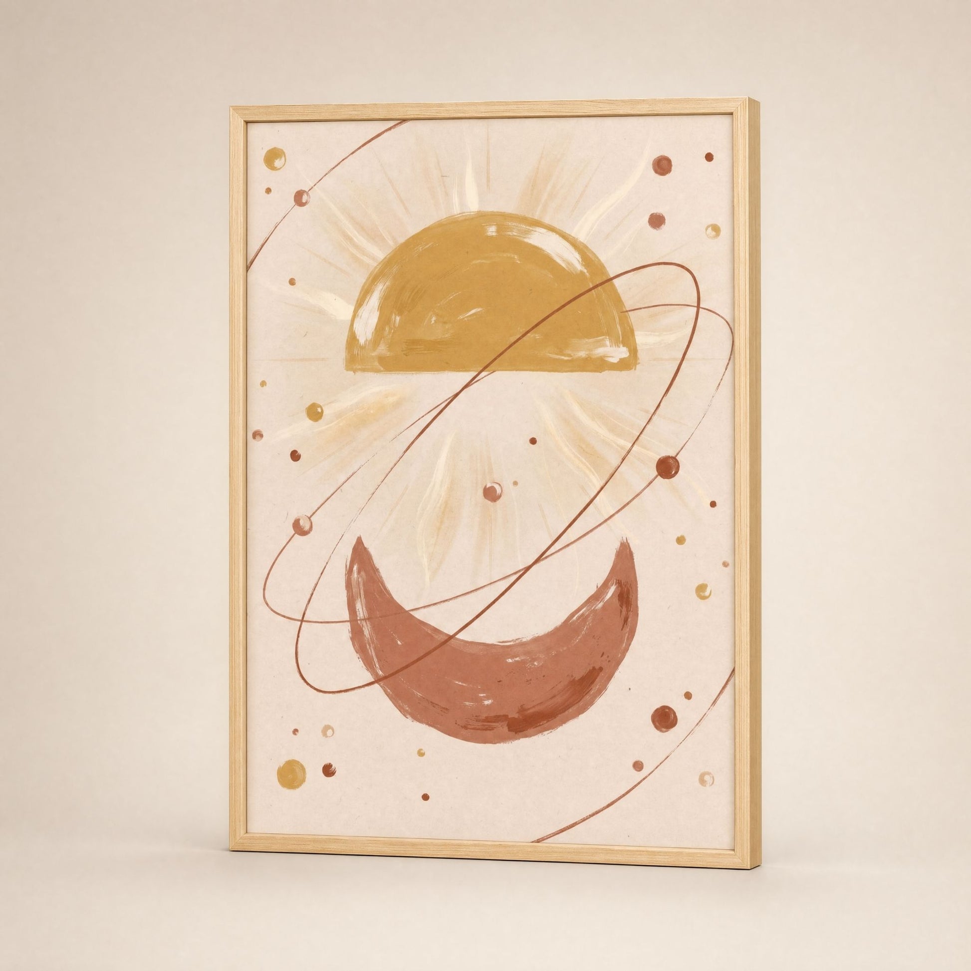 Sun and moon wall art in a natural wood frame, leaning against a pale wall in soft daylight.