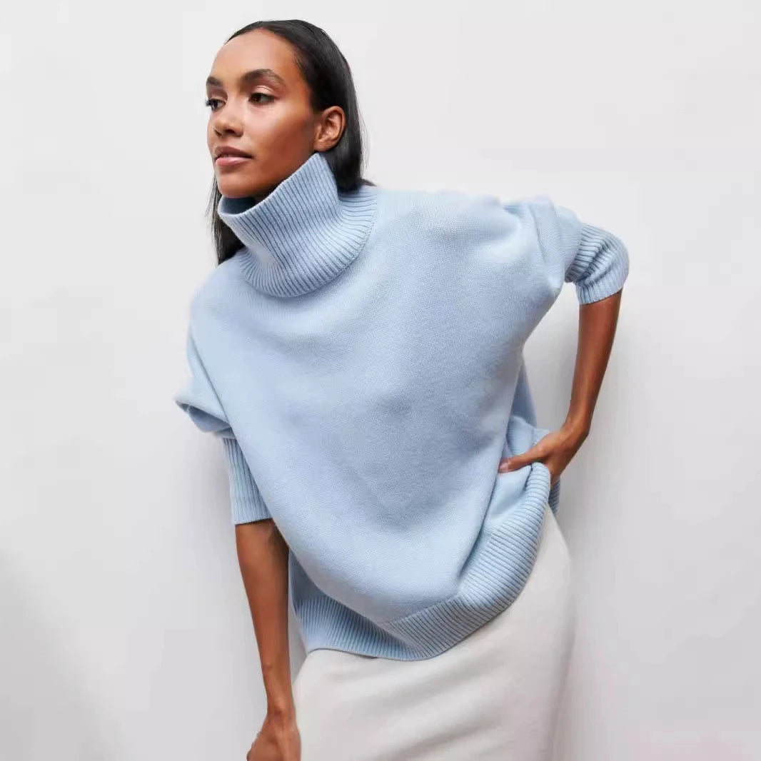 Woman wearing a light blue sweater against a white background