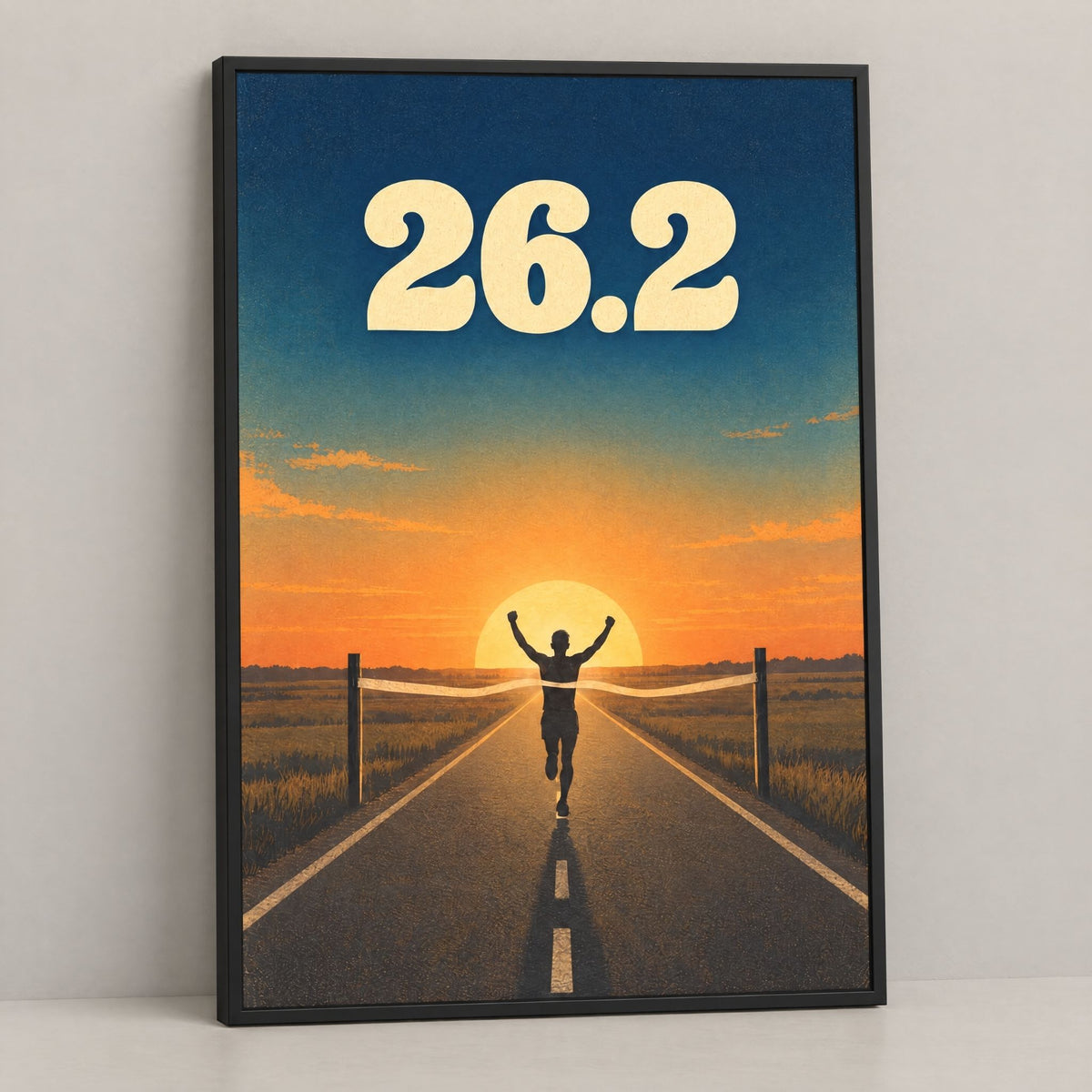 Marathon finish line wall art, a 26.2 runner poster framed in black pine, leaning on a console against a plain wall