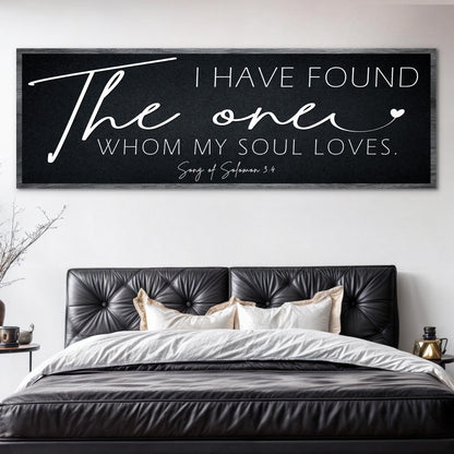 Long black canvas with white script: I have found the one whom my soul loves, Song of Solomon 3:4, above a leather bed