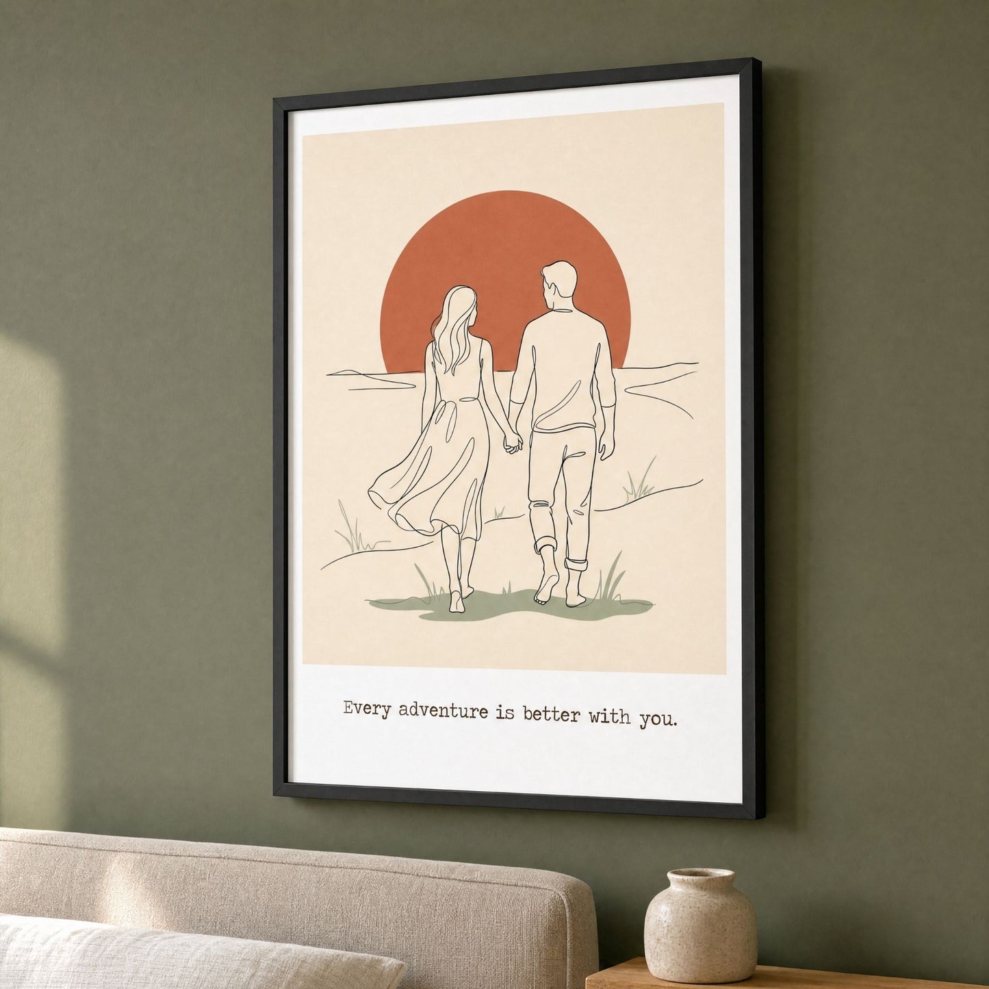 Sunset wall art in a black frame on a deep green living room wall, above a linen sofa.