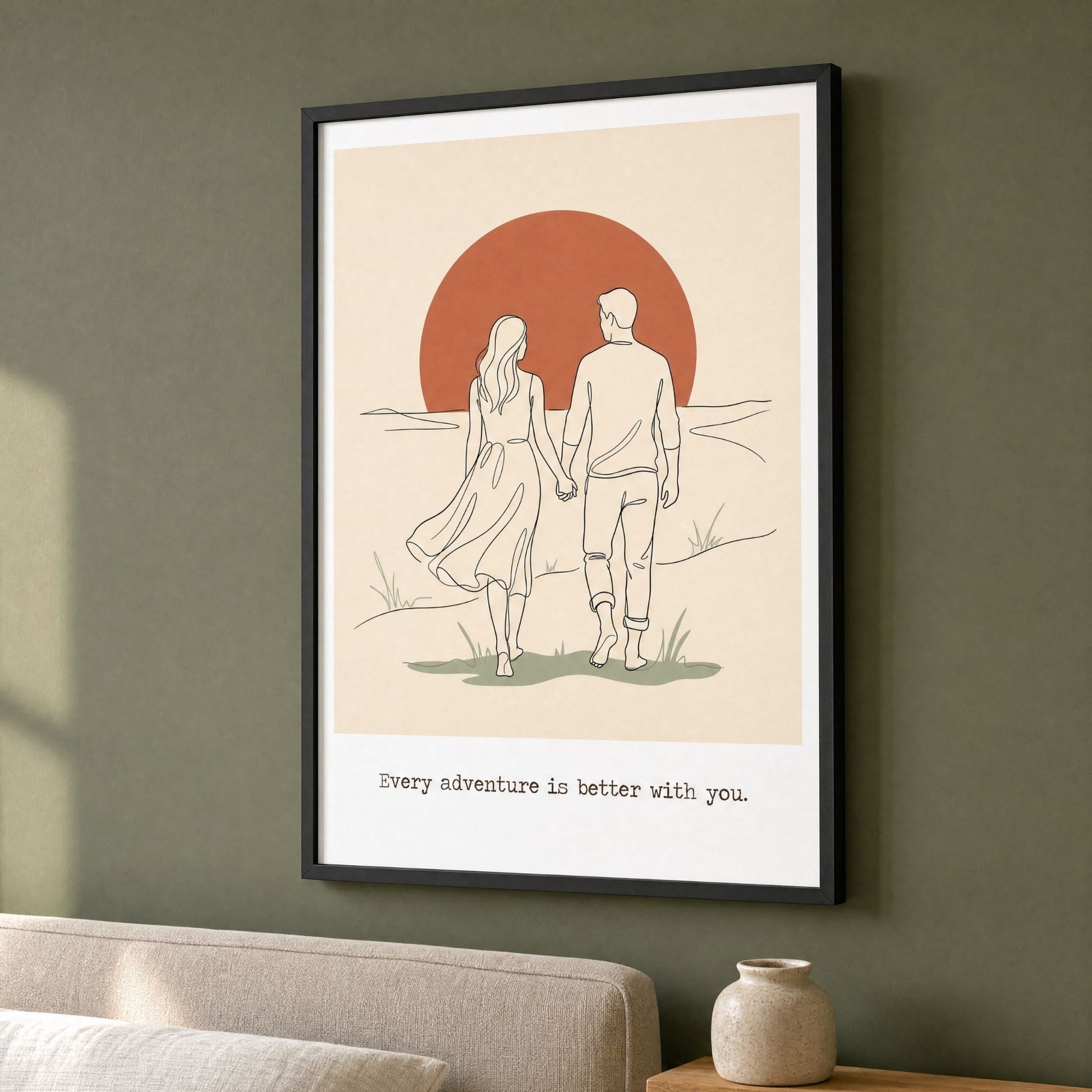 Sunset wall art in a black frame on a deep green living room wall, above a linen sofa.
