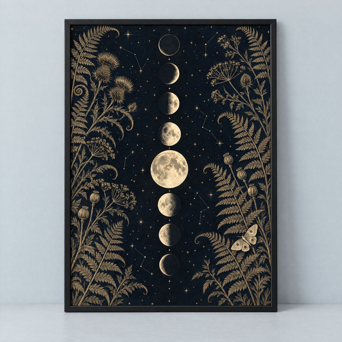 Gothic moon phase wall art in black and gold, framed in black and ready to hang, on a plain pale grey ground