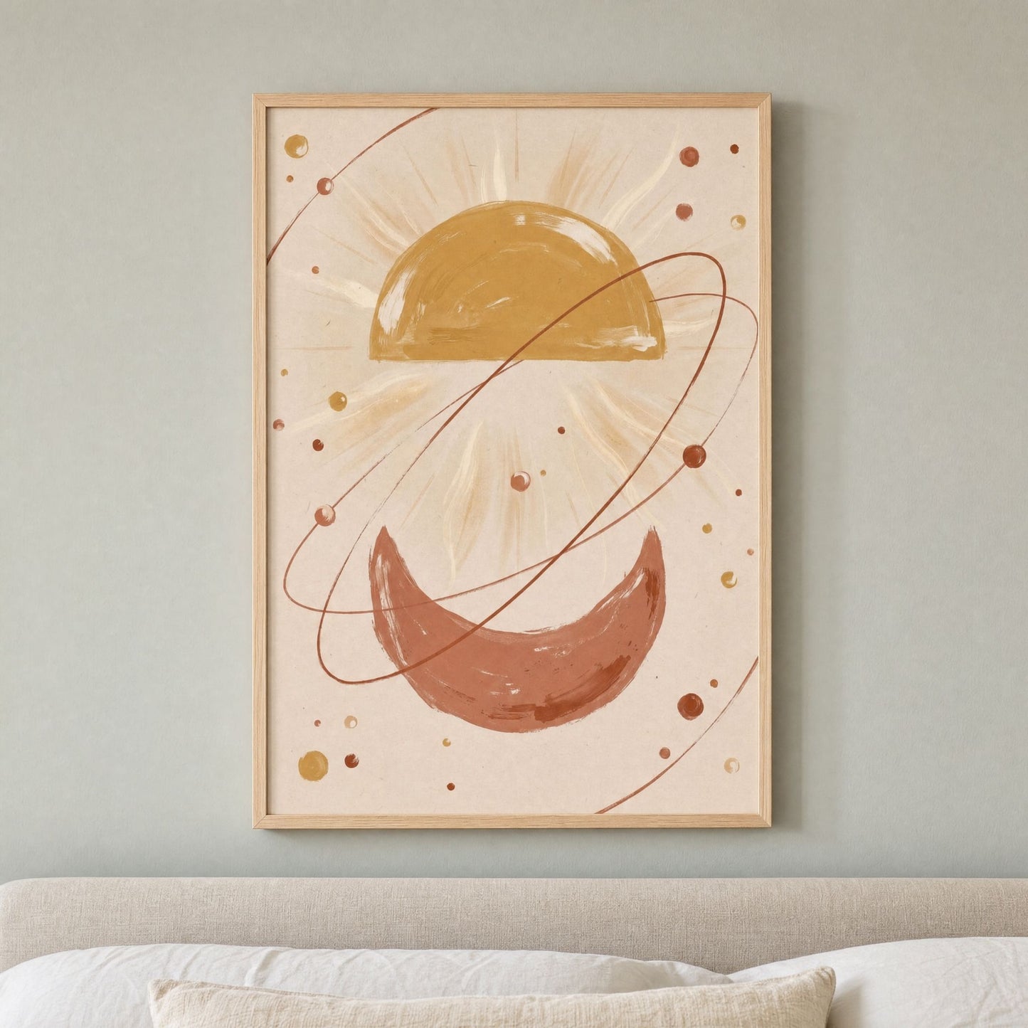 Boho sun wall art in a light wood frame above a bed, on a soft grey-green wall.