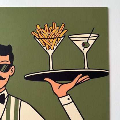 Close-up of the waiter's tray holding a martini of fries and an olive martini on olive green