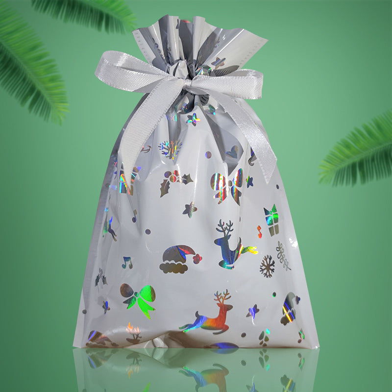 Gift bag with festive designs and a bow on a green background
