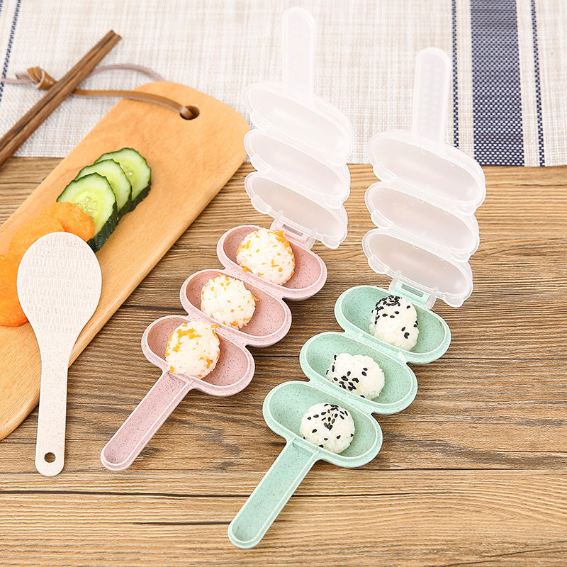 Set of small molds for making rice balls sticks on a wooden surface with a spoon and sliced cucumbers.