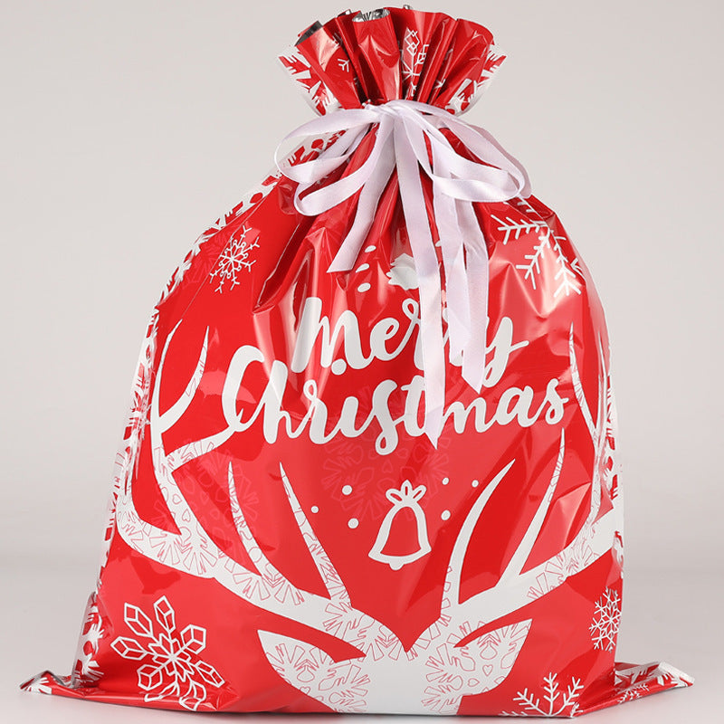 Red Christmas gift bag with white text and patterns on a light gray background