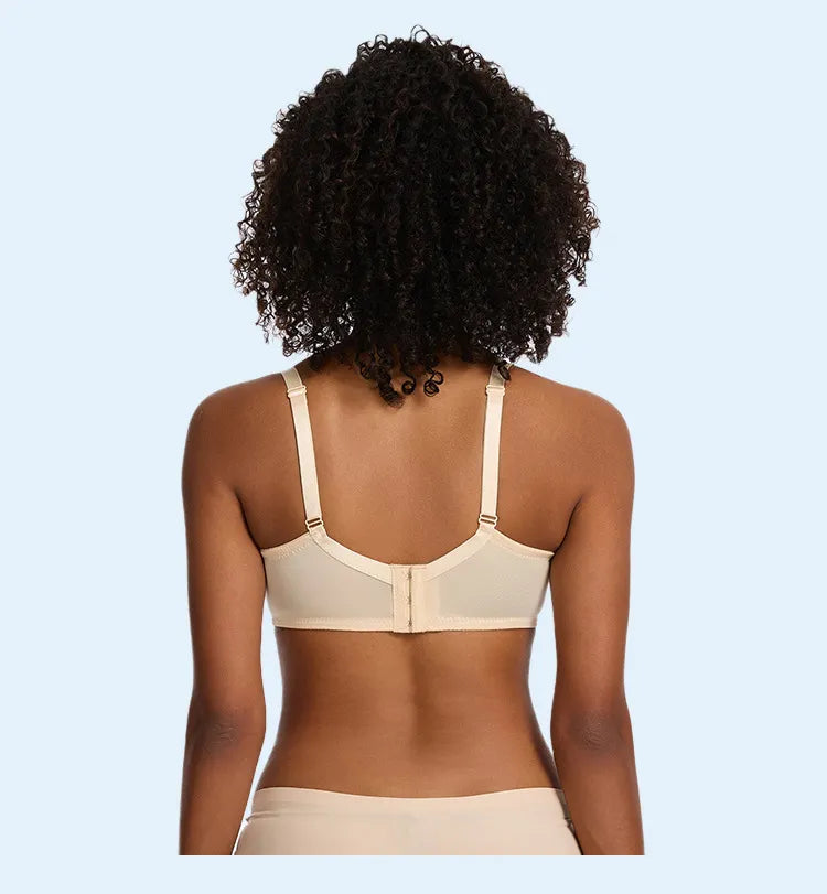 Woman wearing a beige bra against a light blue background