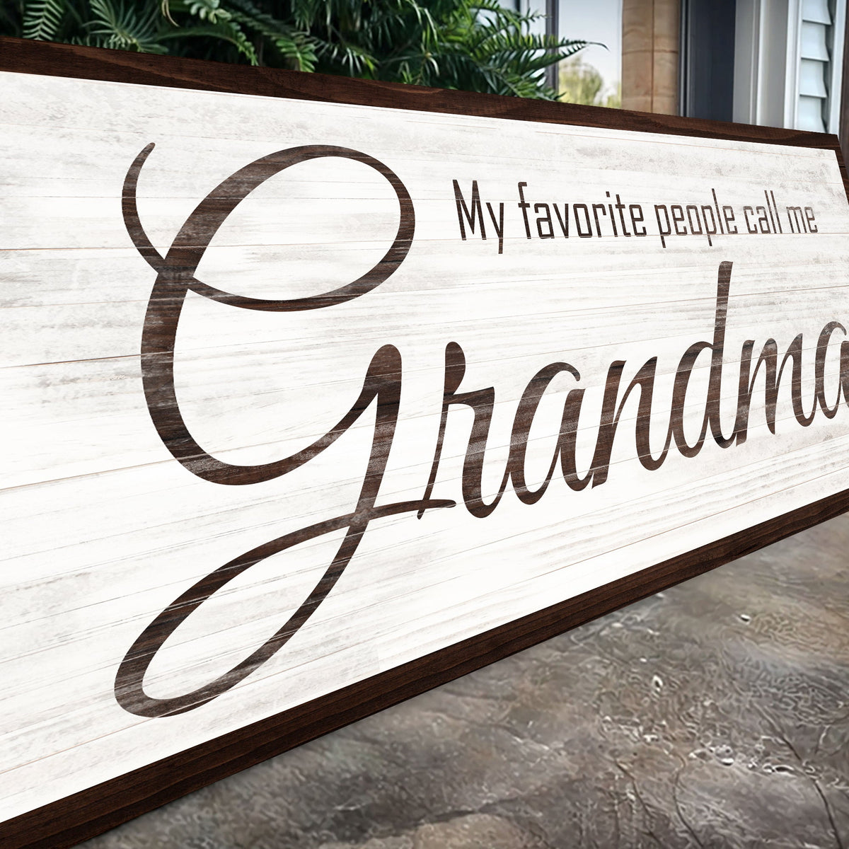Angled close-up of the My Favorite People Call Me Grandma canvas sign showing the brown script on white