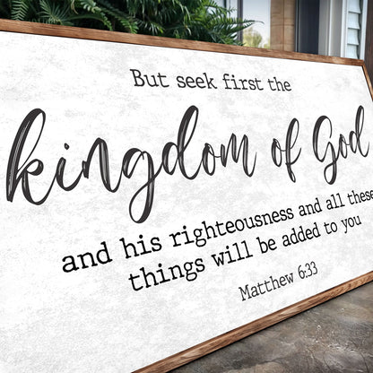 Angled close-up of the Seek First the Kingdom of God canvas sign showing its script and typewriter lettering