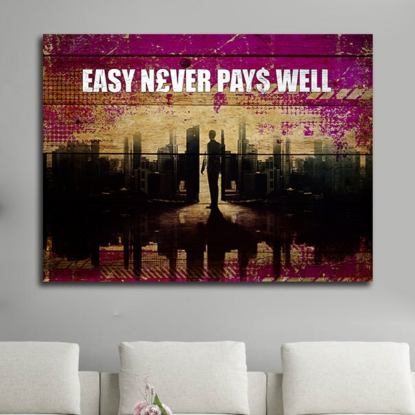 Easy Never Pays Well motivational canvas wall art in an office