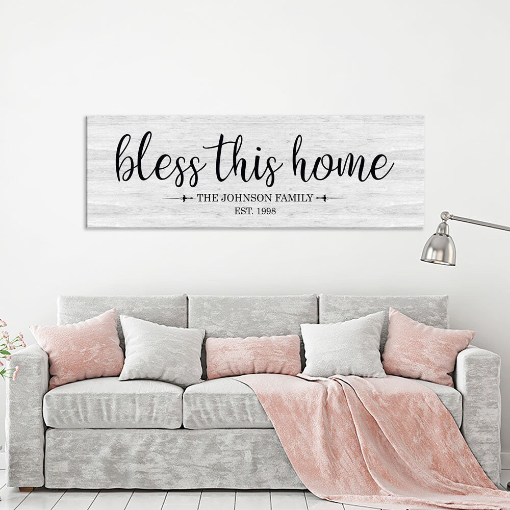 Personalized Bless This Home farmhouse canvas sign above a living room couch