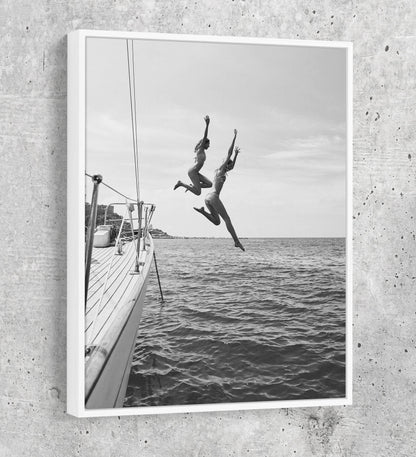 Friends jumping off a yacht into ocean water canvas wall art