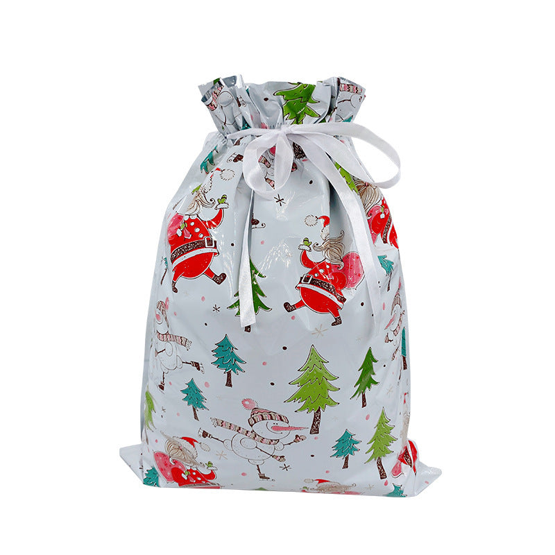 Gift bag with Christmas-themed design featuring Santa Claus and trees on a white background