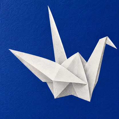 Close up of the paper cranes print showing matte paper grain under the flat ink blue ink