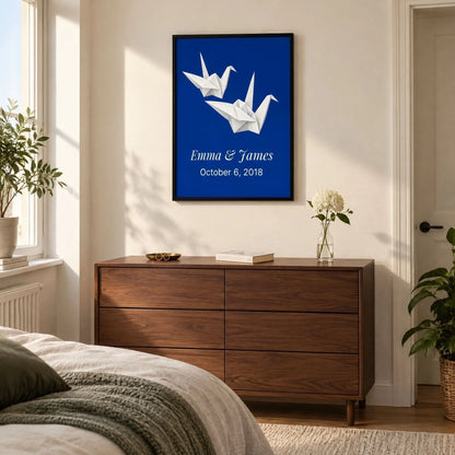 Paper cranes anniversary print in a bedroom above a walnut chest of drawers in morning light