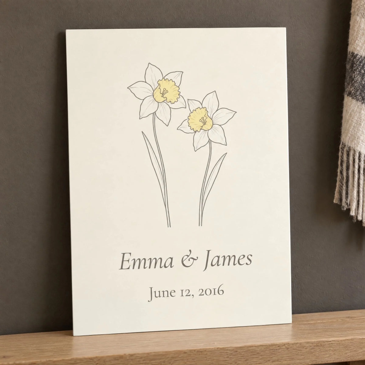 10 year anniversary gift: aluminum daffodil print with names and wedding date resting against a wall