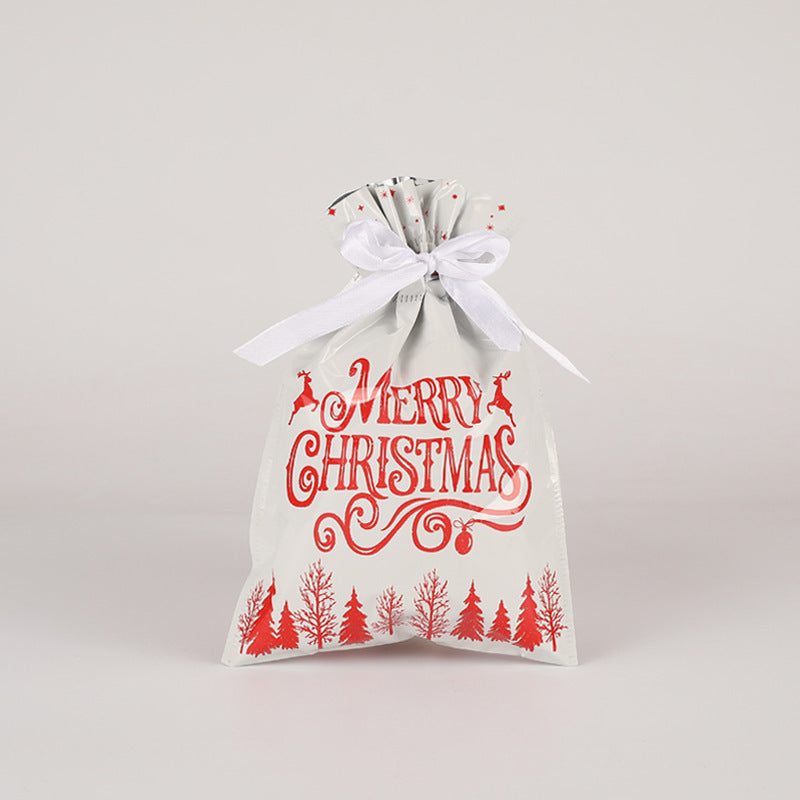 White gift bag with red 'Merry Christmas' text and tree designs on a light gray background